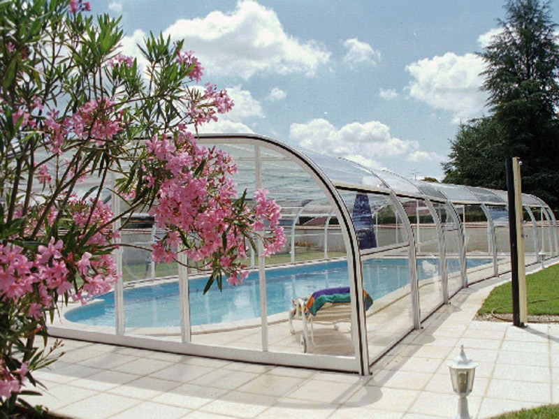 Abri de piscine fixe avec rotonde sur un côté. Large dégagement autour de la piscine. Installé à Bourg-en-Bresse (01)
